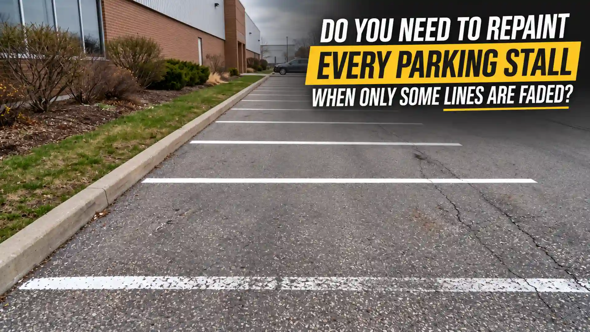 Parking Stall Painting in Whitby showing a commercial parking lot with partially faded white stall lines, cracked asphalt, and parking spaces requiring selective repainting