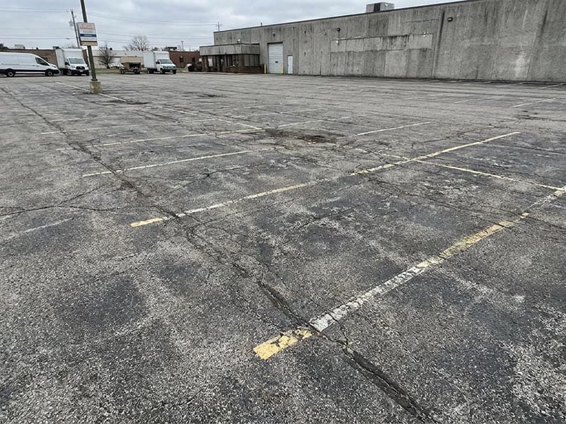 Faded parking lot lines before professional restriping