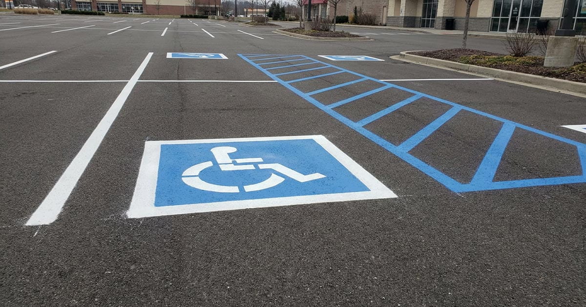 Accessible parking stall marking with wheelchair symbol and access aisle