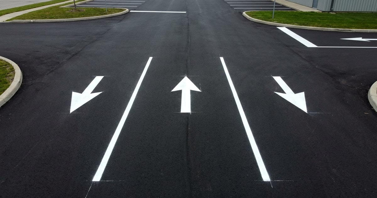 Professional pavement markings including arrows, lanes, and crosswalk lines